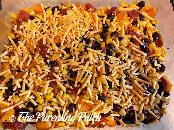 Topping the Cheesy Sweet Potato Black Bean Casserole with Cheese