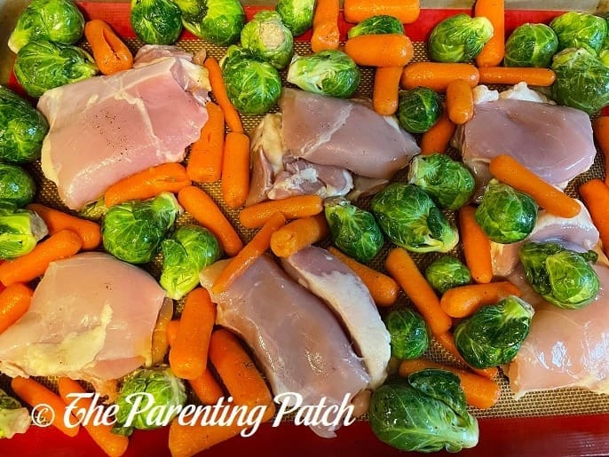 Uncooked Maple-Roasted Pecan Chicken with Carrots and Brussels Sprouts Sheet Pan Meal