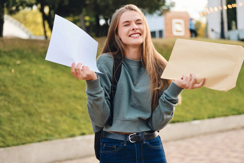 Student opens important letter and celebrates