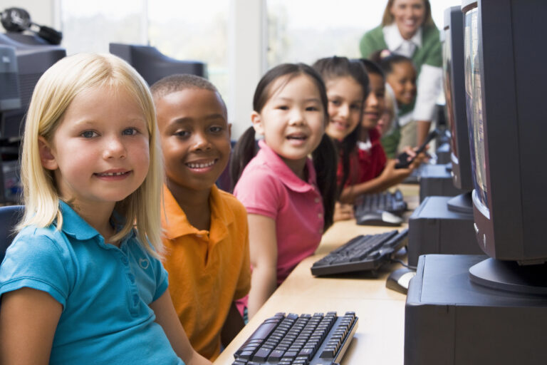 Kindergarten children learning how to use computers.