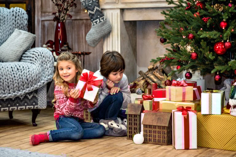 Children sitting near gift boxes