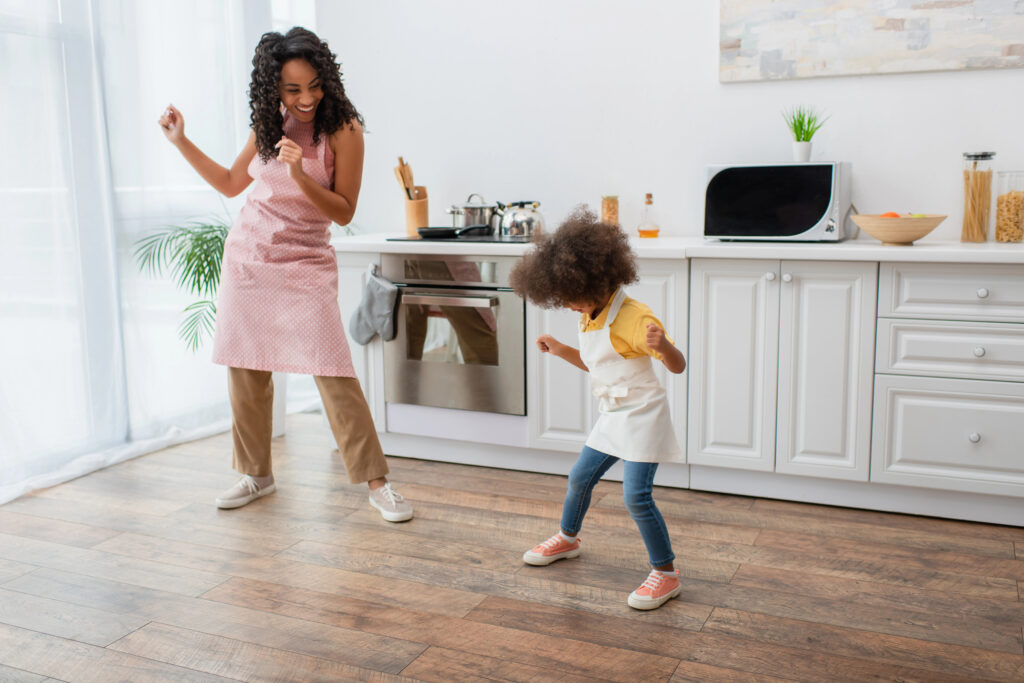 Mom and child dance in home