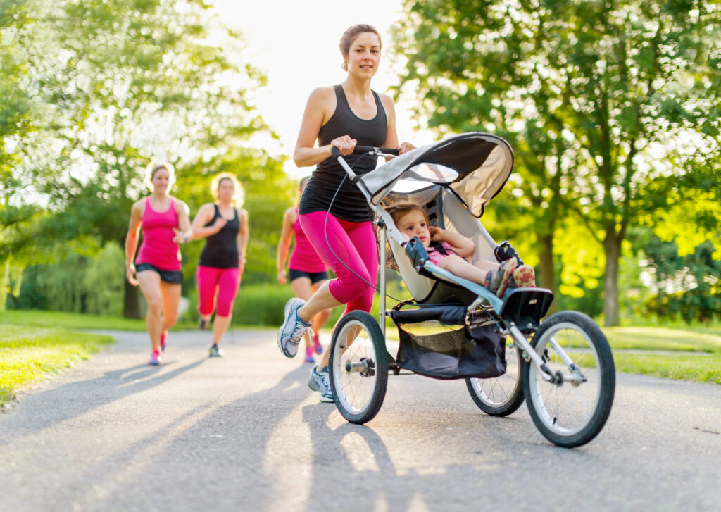 Mom runs with jogging stroller and baby