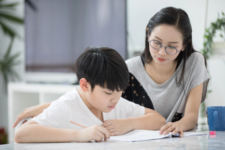Mom helps son practice school testing