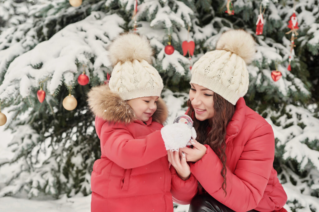 Child plays in snow with mom