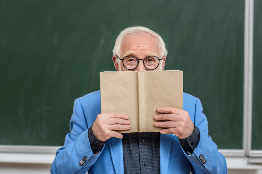 Professor holds up book with no cover or text